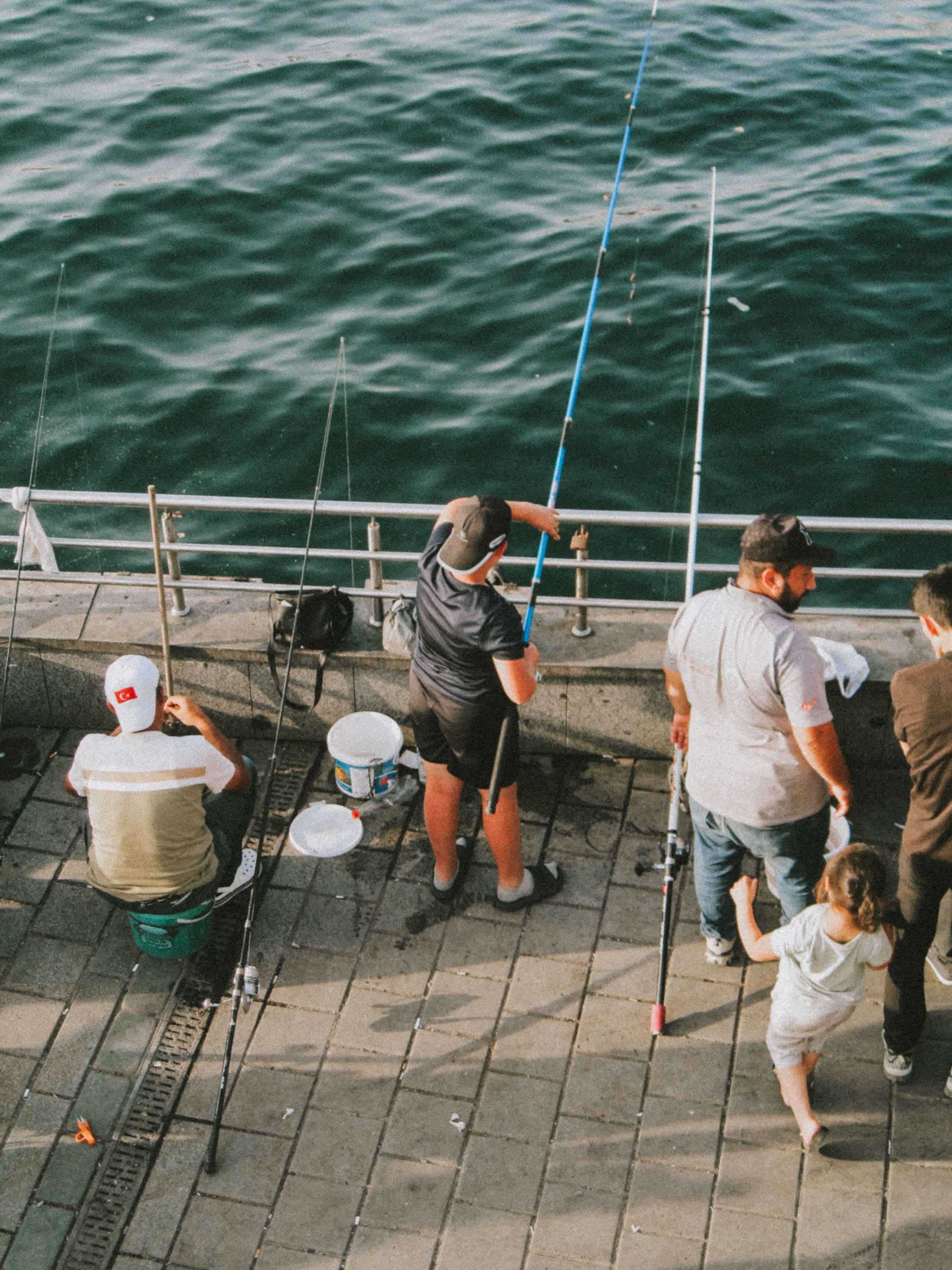Group fishing together from a pier