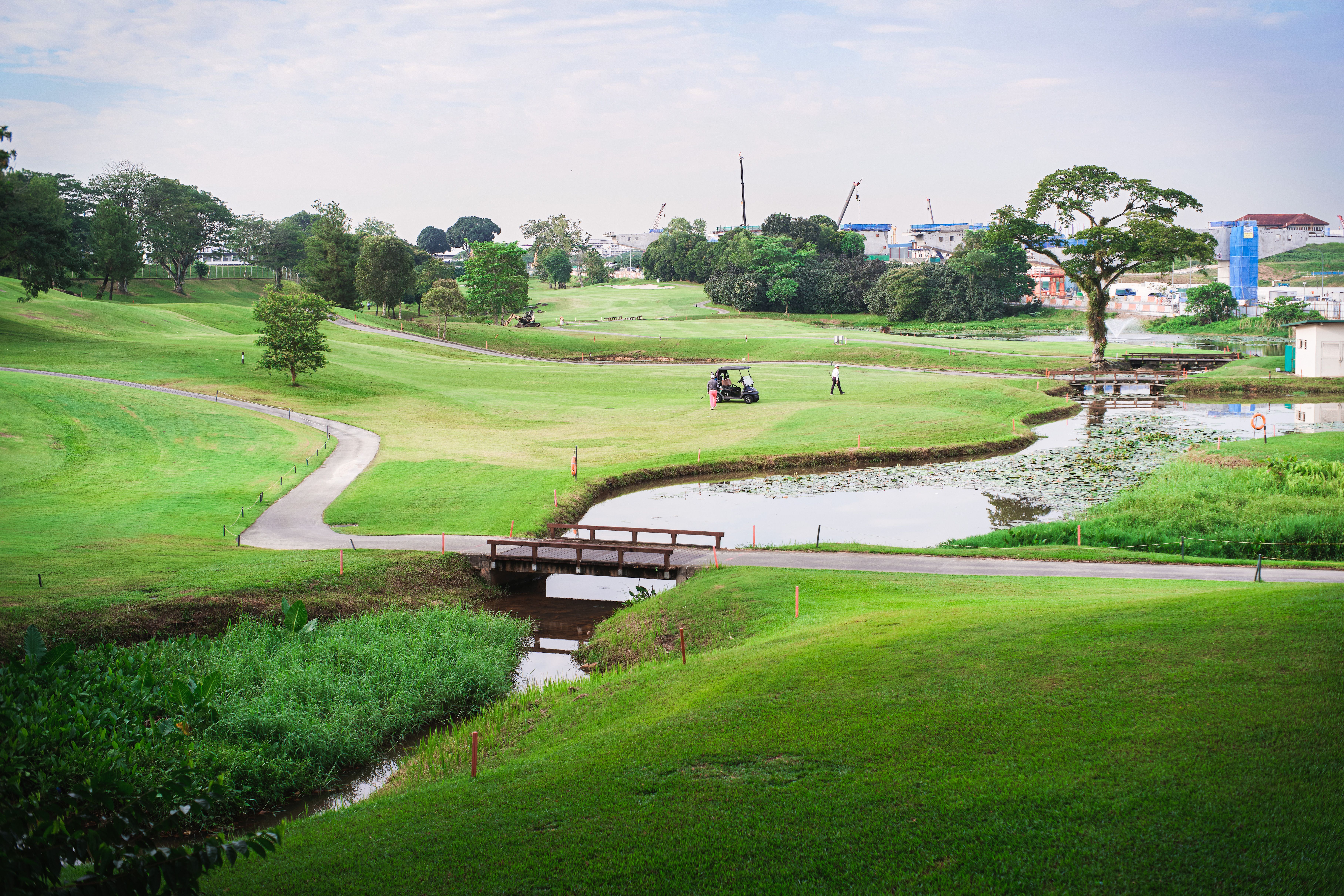 Scenic golf course with water feature and bridge